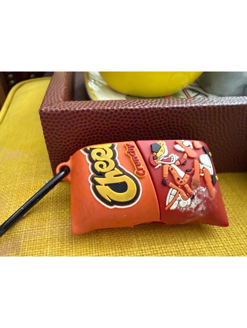 AirPods charger and half of a Cheetos case